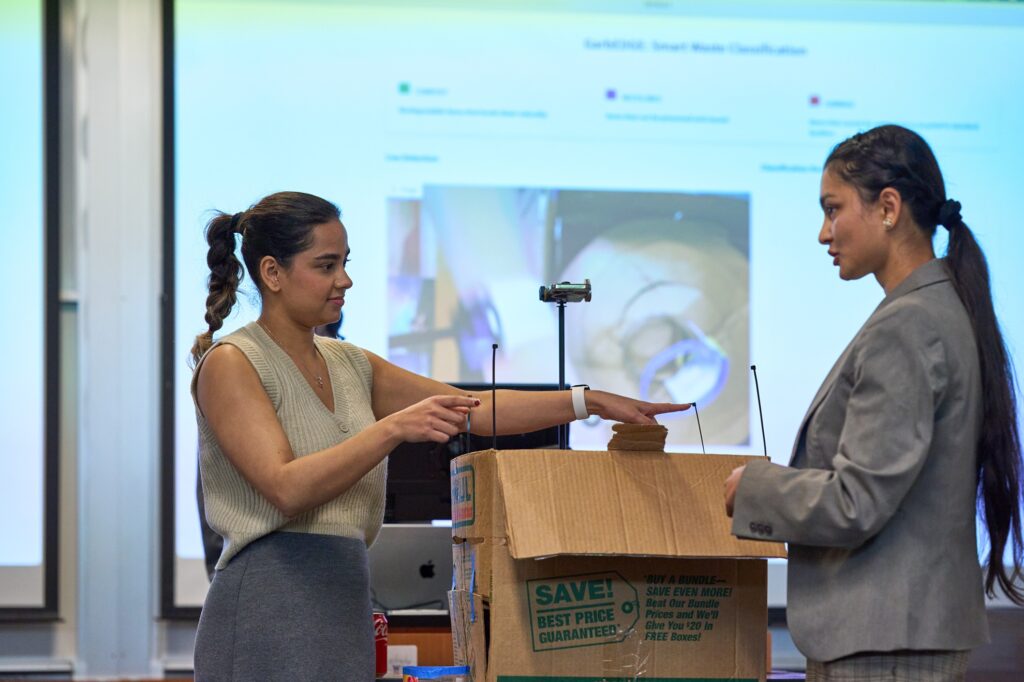 Master of Science in Information Systems students prepare for Demo Day.