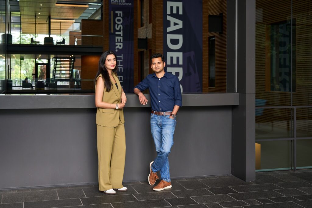 Rabiya Shahid and Sreeram Nambiar standing together inside the PACCAR building at the Foster School of Business, smiling during a campus visit that marked the culmination of their mentorship journey.