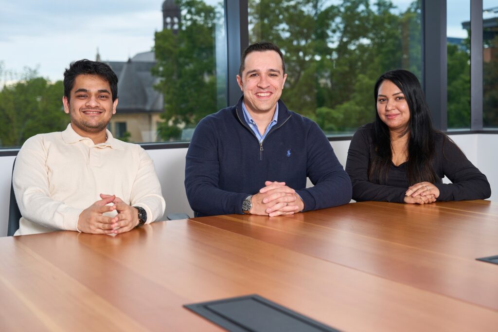 MSCM students Nishant Shah (left) and Nishita Das (right), with their mentor, Justin Gillebo (center).