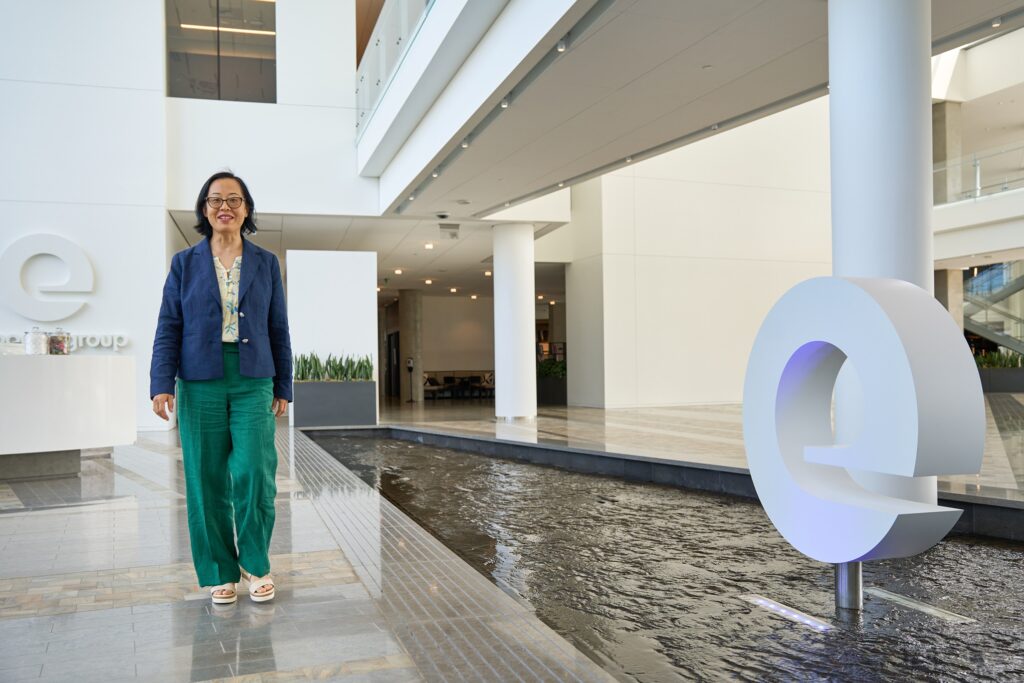 Candid photo of Shiyi Pickrell mid-stride inside the Expedia Group office. The image echoes her career philosophy: stay active, stay curious, and embrace change.