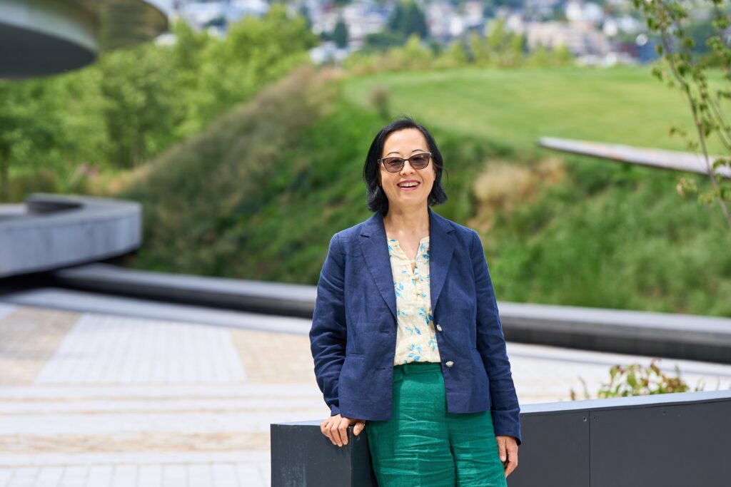 Set against the backdrop of a clear Seattle sky, Shiyi Pickrell enjoys the view from Expedia Group’s waterfront campus. 